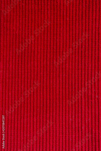 Red corduroy fabric texture background with vertical ribbed pattern