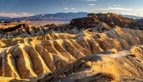 Expansive Eroded Badlands Landscape Bathed in Golden Sunset Light, Showcasing Geological Wonders