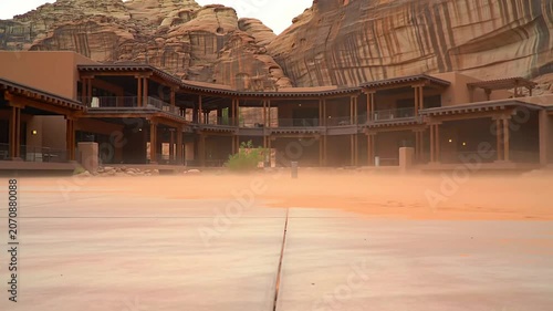 Stunning Static View Of Luxury Desert Resort's Skeletal Frame Integrated Into Rocky Terrain With Modern Architecture In Warm Tones