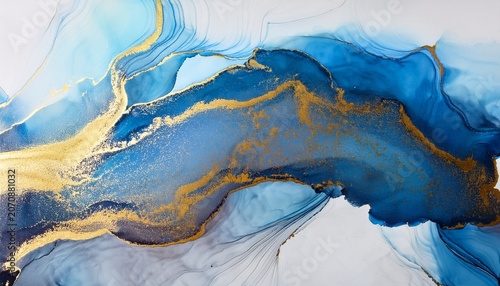 abstract alcohol ink spreading on art paper creating fluid gold and blue contemporary pattern