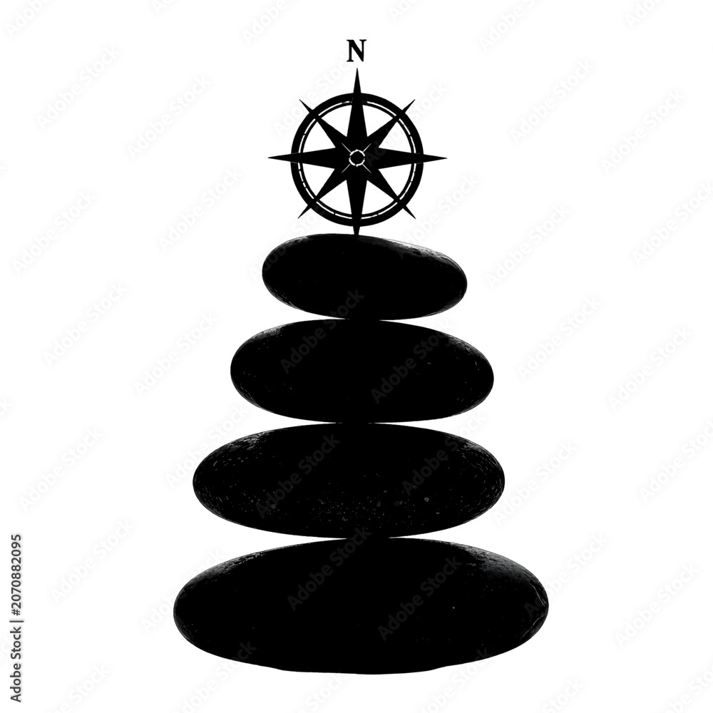 Fotografie Stacked stones topped with a compass indicating direction