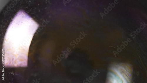 Closeup of Light Refracting Through Liquid with Purple and Yellow Reflections