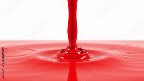 Single Red Liquid Drop Falling in Slow Motion Against Clean White Background