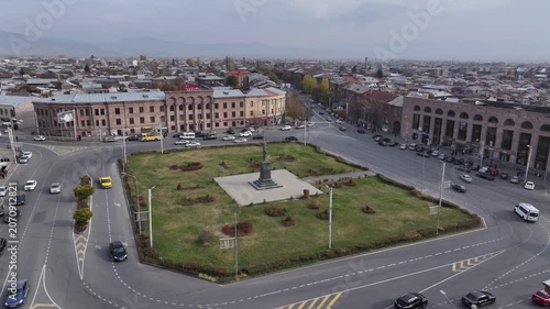 Aerial drone shot of the beautiful city of Gyumri in Armenia, showcasing its historic architecture, busy city squares, streets, and the famous landmark Holy Saviour's Church during autumn.

