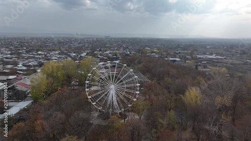 Aerial drone shot of the beautiful city of Gyumri in Armenia, showcasing its historic architecture, busy city squares, streets, and the famous landmark Holy Saviour's Church during autumn.

