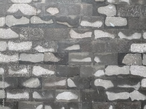 Textured Gray Stone Wall Background with Organic Light and Shadow Patterns