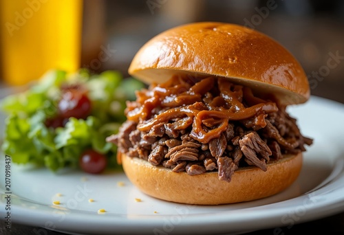 Restaurant style pulled beef sandwich, perfectly arranged shredded beef, brioche bun, homemade sauce, caramelized onions, fresh salad.