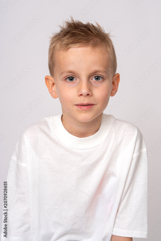 Fototapeta premium Portrait of a cute preteen boy in white t-shirt