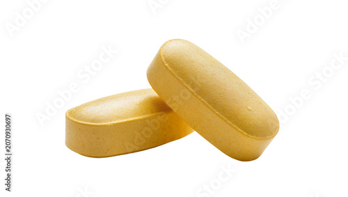 Cuadro en lienzo Isolated two textured yellow orange oblong vitamin pills or dietary supplements close-up