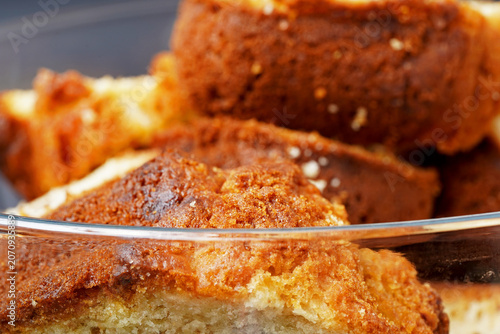 Close-up of freshly baked raisin cake slices with a golden brown crust and soft crumb texture.