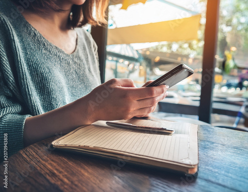 Hands Using Smartphone at Outdoor Cafe With Scenic Urban Background View