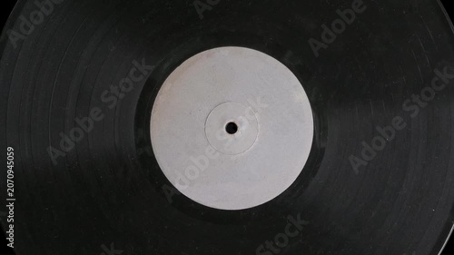 Grunge spinning vinyl record on black background. turntable vinyl record