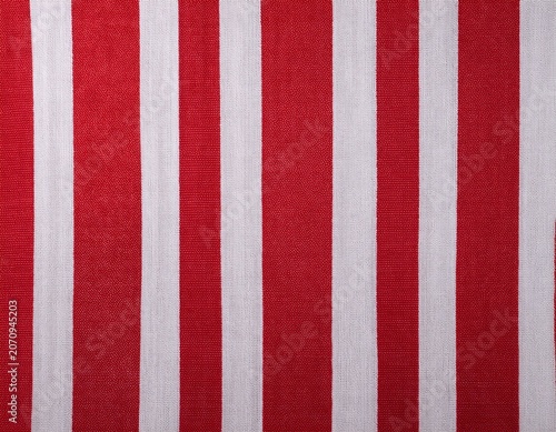 red and white striped fabric background showing a textured textile weave for various design purposes highlighting the vertical pattern and classic color combination