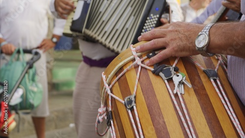 Musicians playing a drum and accordion during a traditional romería cultural event in the Canary Islands, symbolizing local heritage and festive celebrations