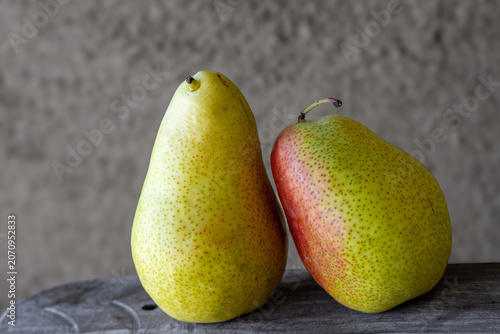 Foto Sill life of a pair of pears against  at mottled grey background