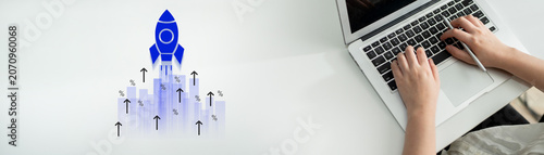 Принти на полотні A modern workspace featuring a laptop with a creative rocket illustration symbolizing growth and innovation, perfect for themes of business development and entrepreneurial strategy