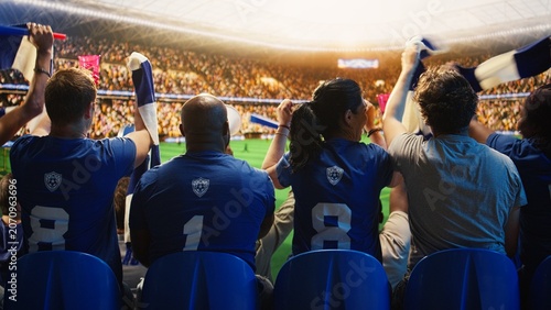 Fotografía Close-up of football supporters singing in stadium grandstands during match day for football fan and match day concepts