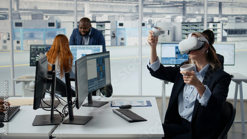 Fotografie Woman in manufacturing lab using VR goggles to design energy efficient semiconductors, Female engineer using virtual reality simulation to upgrade microchip hardware production, camera A
