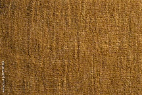 Closeup texture of yellow woven textile material. Perfect backdrop for minimalist designs, fashion moodboards, home decor templates or organic product photography background