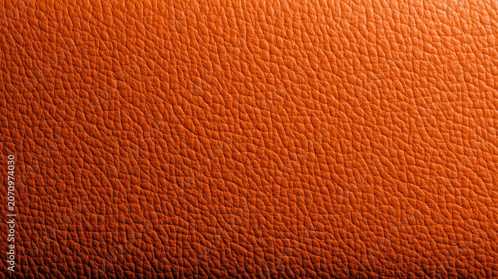 Fototapeta premium Close-up of vibrant orange grained leather texture background