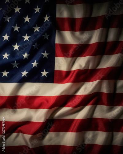 Dark patriotic american flag background with dramatic waving fabric