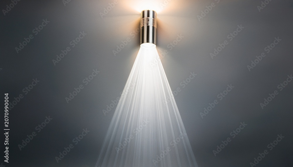 Obraz premium a bright beam of light from a flashlight shines on a gray background