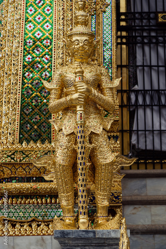 Canvas Print A golden guardian statue stands guard outside a temple at The Grand Palace, Bang