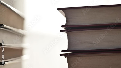 Reading books, training and learning concepts. Stack Of Books Close Up. book pages and sun glare. 4k footage
