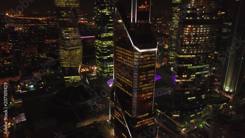 Drone circling Moscow City skyscrapers at night