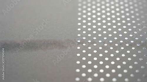 Close up of a textured silver surface with shiny polka dot pattern