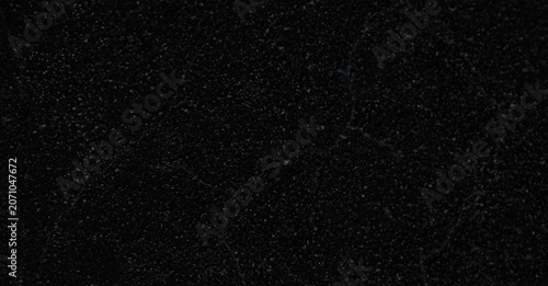 Black granite texture with subtle white speckles, dark polished stone surface background, natural marble mineral grain for luxury interior design