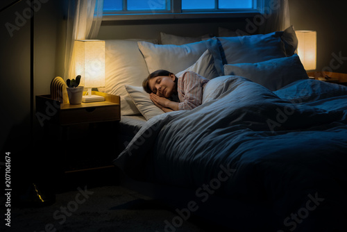 Konstfotografi Woman sleeping peacefully in bed at night