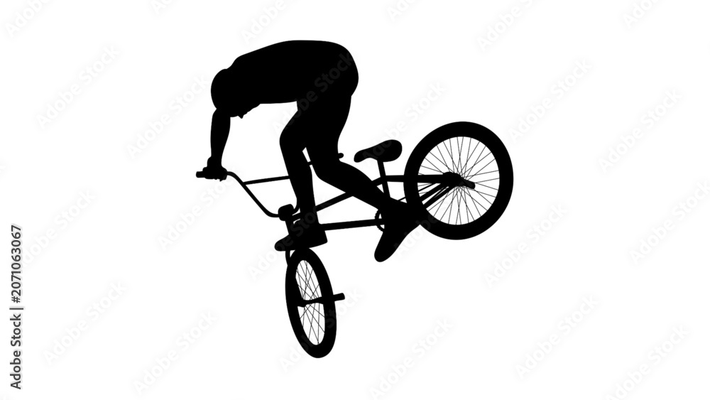 Fototapeta premium Silhouette of a BMX rider performing a stunt trick on a bicycle