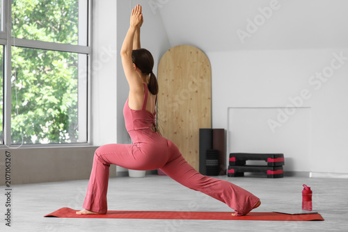 Woman practicing yoga warri...