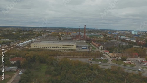 Drone flying sideways over industrial zone