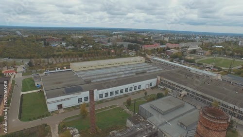 Drone flying forward over factory roof