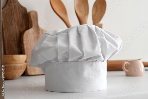 Chefs hat with utensils on ...