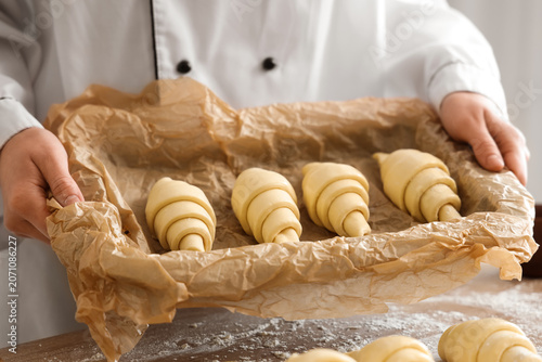 Female baker holding baking...