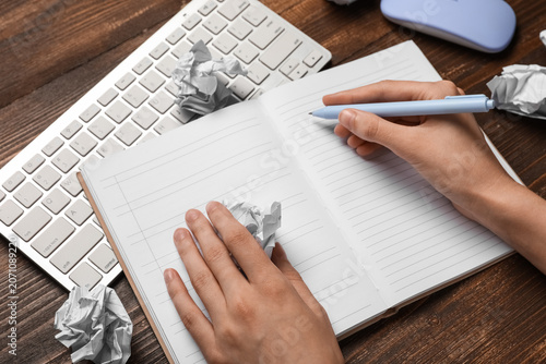Female hands with notebook ...