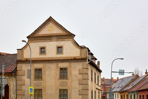 Konstfotografi Historic synagogue building with star of david on rooftop in quiet european town