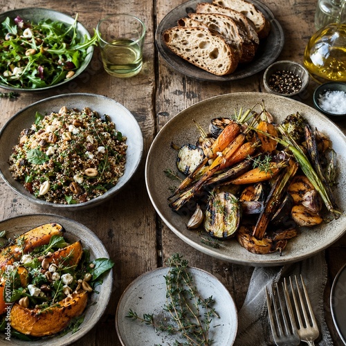 Farm to table restaurant spread with roasted vegetables bread and herbs