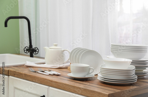 Clean white dishes and cutl...