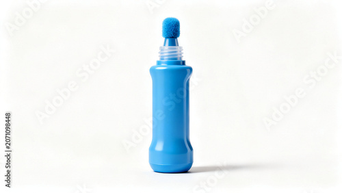 A bright blue bingo dauber marker with a sponge tip and cylindrical body standing upright on white surface.