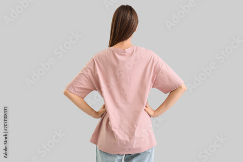 Young woman in pink t-shirt...
