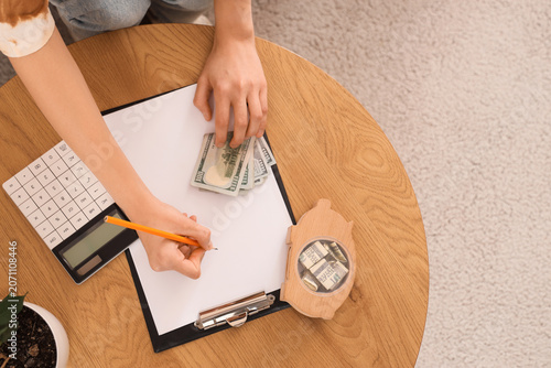 Young woman counting money ...