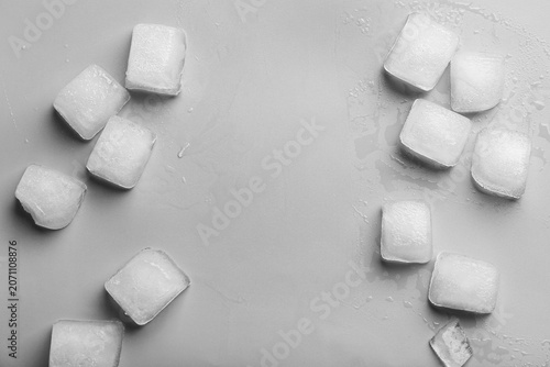 Many frozen ice cubes on gr...