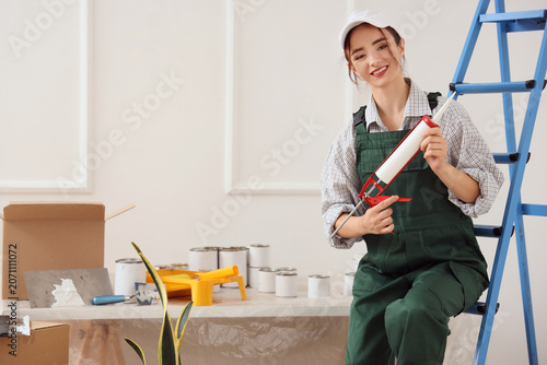 Female worker with sealant ...