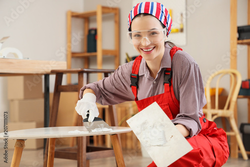 Female decorator putting pu...