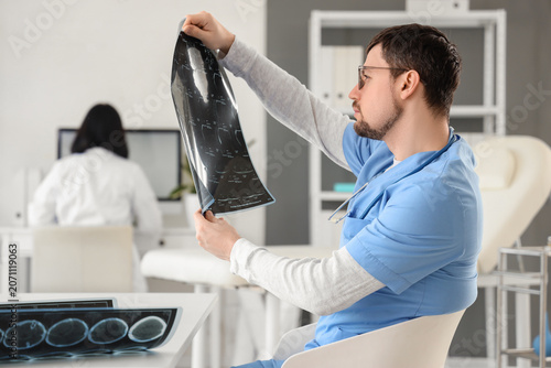 Male doctor studying x-ray ...