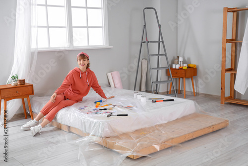 Young woman with paint tool...